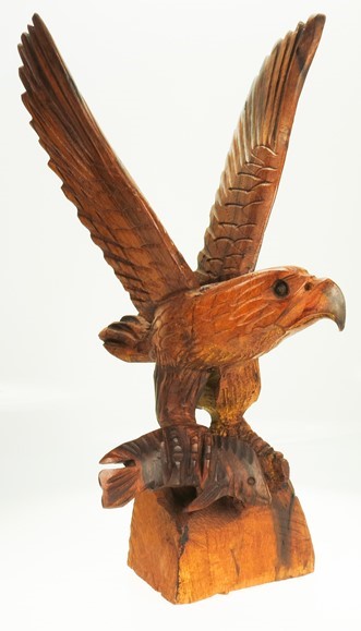 Eagle wings spread with fish